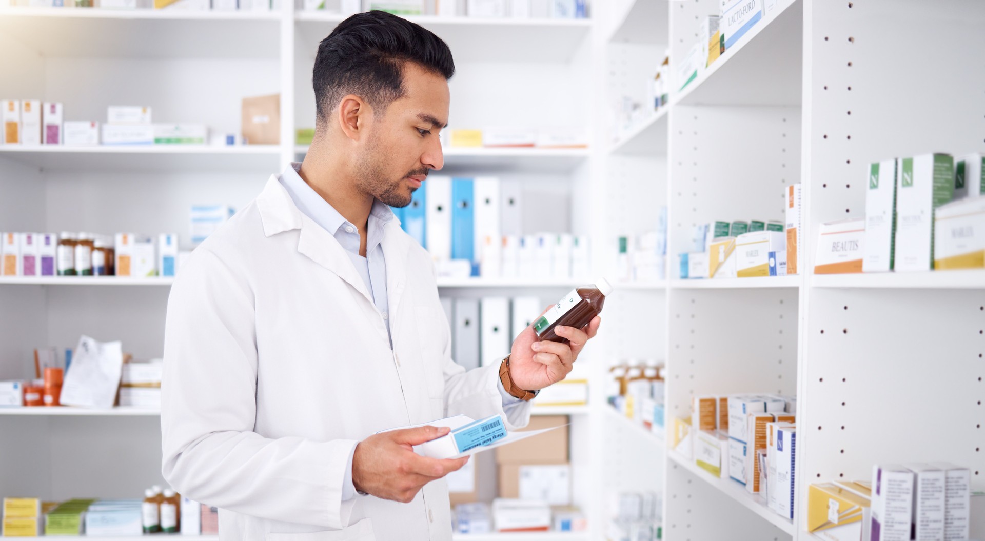Farmacéutico, medicina y hombre con botella para consultar stock en farmacia. Medicamentos, inventario y etiqueta de lectura del médico sobre medicamentos farmacéuticos, suplementos e información para la atención médica.